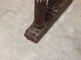 a close up of a wooden table with a vase on it