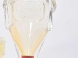 a small glass vase with a flower inside of it