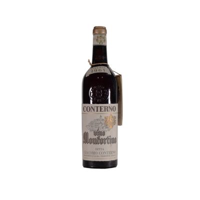 the bottle of wine is sitting on a white surface