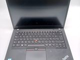 a laptop with a black keyboard on a white surface