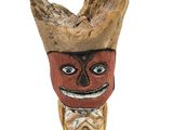 a wooden figurine of a man with a hat on it ' s head