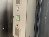 an electric panel mounted to the side of a wall next to a metal door