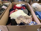a cardboard box full of clothes in a room