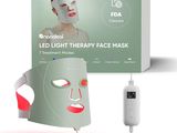 une boîte contenant un masque facial de luminothérapie à LED, à côté d'une boîte blanche