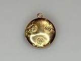 an image of a gold pendant with a dragon on it