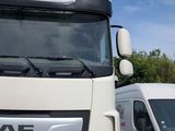 two trucks parked next to each other in a field
