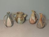 five different types of vases sitting on a table