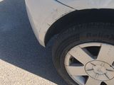 a close up of a car ' s tire on the street