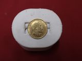 a gold coin sitting on top of a white box