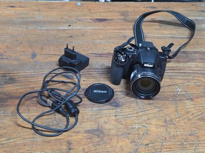 a camera with a lens attached to it on a wooden table