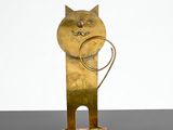 sculpture of a cat with a ring in its mouth on a black surface