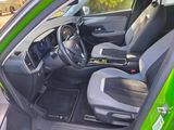 the interior of a green car with a steering wheel and dashboard