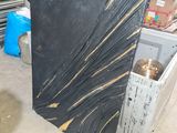 a black and gold marble slab in the middle of a room