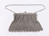 an antique silver mesh purse with chain strap and clasp