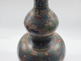 a vase that is sitting on a white surface