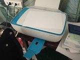 a printer sitting on top of a desk next to a bag