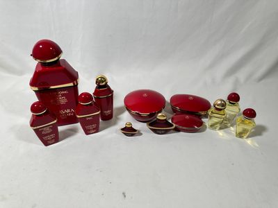 a close up of a group of bottles of perfume on a white surface