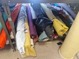 many different colored cloths on a rack in a room