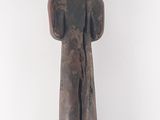 an image of a wooden sculpture of a woman with a bird on her head