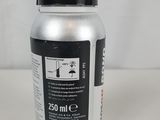 a close up of a bottle of liquid sitting on a table
