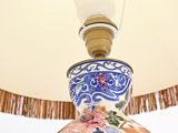 a lamp that is sitting on a table with a lamp shade on it