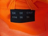 an orange shirt with a black label on it