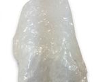 clear quartz rock on a white background with a small piece of rock in the middle