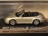 a silver toy car in a clear display case