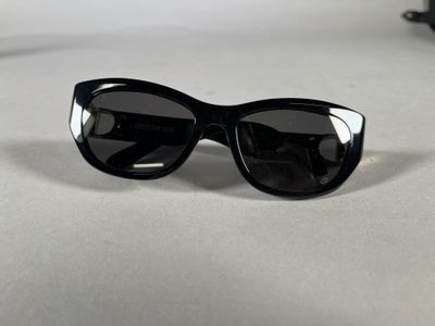 black sunglasses on a white surface with a pair of black glasses
