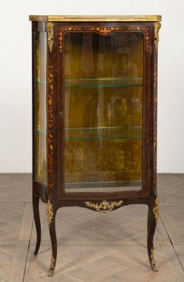 an antique display cabinet with a glass door and gold trimming