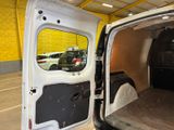 a white van with the door open in a garage