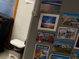 a refrigerator in the corner of a room with a lot of magnets on it