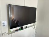 a flat screen tv mounted on a wall in a living room