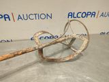 a close up of a metal object on a table with a sign in the background