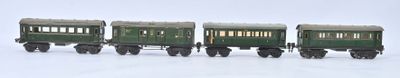 four toy trains that are lined up on a white surface