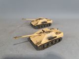 two toy tanks sitting on top of a table next to each other
