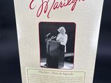 a box with a picture of a woman standing at a podium