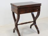 a small wooden table with a drawer on top of it