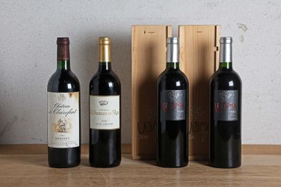 three bottles of wine are lined up on a table next to a wooden box