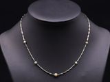 a necklace with pearls on a mannequin mannequin