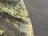 a close up of a knife with a yellow substance on it