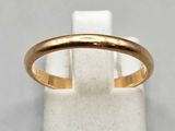 a close up of a gold ring on a white surface