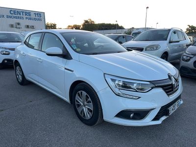 a white car parked in a lot with other cars in the background