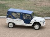 a small white and blue jeep parked in a parking lot