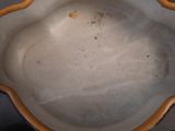 a yellow and white bowl sitting on a table