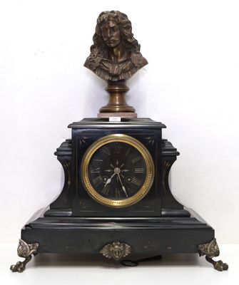 a clock with a bust of a man on top of it