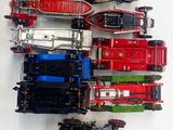 several toy trains are lined up on a white surface