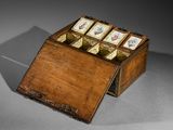 a small wooden box with cards in it on a table