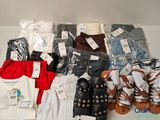 many pairs of clothes and sandals on a table