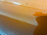 a reflection of a person on a boat in the water